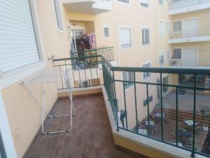 a balcony with a glass table on a building at Almancil Park Apartment in Almancil