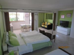 a bedroom with a bed and a living room at Haus Roko in Rovinj