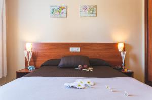 a bedroom with a bed with flowers on it at Cactus in Puerto del Carmen +25 photos