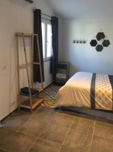 a bedroom with a bed and a ladder in it at Ogooué Studio in Carpentras