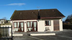 a small white house with a brown roof at The Old Rectory - Brean in Brean