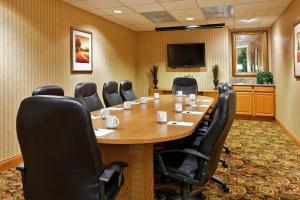 a conference room with a large wooden table and chairs at Country Inn & Suites by Radisson, Sycamore, IL in Sycamore