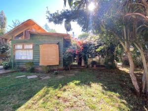 a house with a tree in front of it at Pisco Elqui HolidayHome in Pisco Elqui