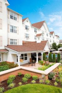 a large white house with a patio and a yard at Sonesta Simply Suites Seattle Renton in Renton