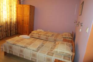 two twin beds in a room with a door at Gerdjika Hotel in Nesebar