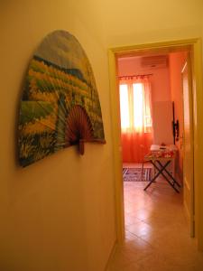 a room with a painting on the wall and a hallway at CASA Melone Giallo in Paceco