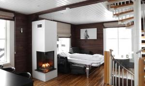a living room with a fireplace and a bed at Mosetertoppen Panorama anneks 3B in Hafjell