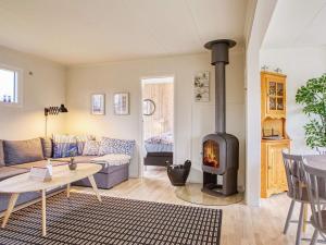 a living room with a couch and a fireplace at 4 person holiday home in Svendborg in Svendborg
