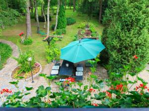 an overhead view of a garden with a blue umbrella at Lovely Apartment in Rusko with Pool Garden in Darłowo