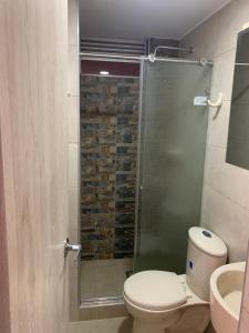 a bathroom with a shower with a toilet and a sink at Apartamento Vacacional Toscana Melgar in Melgar