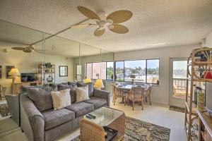 a living room with a couch and a ceiling fan at Burnt Store Marina Condo Boat, Swim, Golf! in Burnt Store Marina