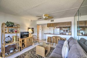 a living room with a couch and a kitchen at Burnt Store Marina Condo Boat, Swim, Golf! in Burnt Store Marina