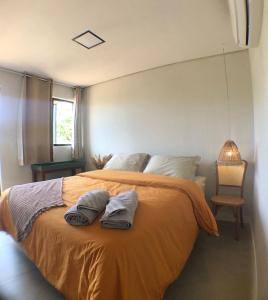um quarto com uma cama com duas toalhas em Oby Noronha em Fernando de Noronha