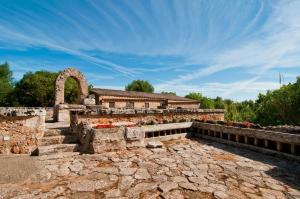 a large stone building with a clock on it at Finca Son Sureda Agroturismo in Manacor