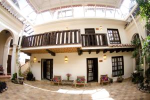 a large building with a balcony and a walkway at Hotel Casa Selah in San Cristóbal de Las Casas