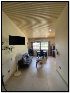 a living room with a couch and a table at Beach Break Santa Teresa in Santa Teresa Beach