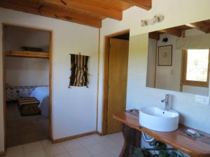 a bathroom with a sink and a mirror at Cabaña Paseo del Sol in San Martín de los Andes