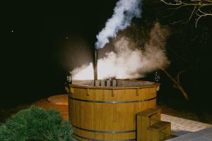 a wooden barrel with smoke coming out of it at Rai pe Vale Boutique & Spa in Leordina