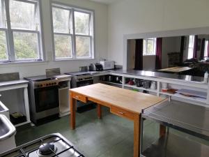 a large kitchen with a wooden table in it at Taylor Lodge in Erua