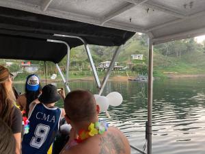 un grupo de personas en un barco en el agua en Finca Isla El Paraiso, en Guatapé