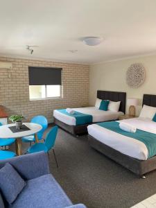 a living room filled with furniture and a couch at Beach Park Motel in Wollongong