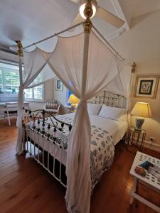 a bedroom with a bed with a canopy at Arcadia House in Byron Bay