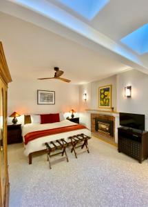 a bedroom with a large bed and a fireplace at Otter's Pond Bed and Breakfast in Eastsound