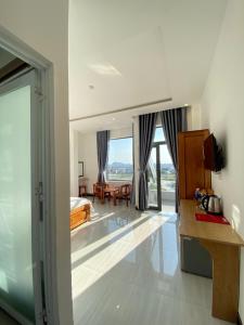 a hotel room with a view of a bedroom at Queen Hotel in Tuy Hoa