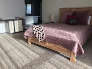 a bedroom with a large bed with a wooden frame at Sunsea Waterfront South Yunderup in South Yunderup +10 photos