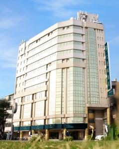 a large white building with a lot of windows at Hotel Avenue in Hsinchu City