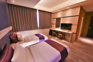 Postel nebo postele na pokoji v ubytování Yu Kun Tien Hotel