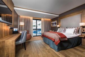 a hotel room with a bed and a desk and a desk at Vestlia Resort in Geilo