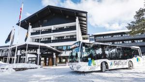 a bus parked in front of a building in the snow at Bardøla Fjelltun in Geilo