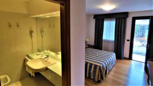 Posteľ alebo postele v izbe v ubytovaní Hotel Luna