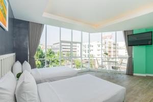 
a hotel room with a large window overlooking the ocean at Ratchada Point Hotel in Bangkok
