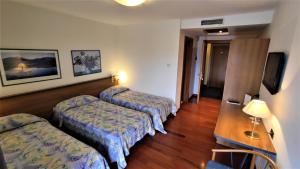 Posteľ alebo postele v izbe v ubytovaní Hotel Luna