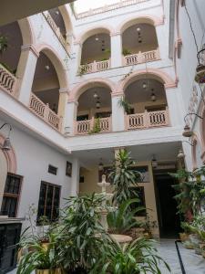 a building with balconies and plants in a courtyard at Kanhaia Haveli in Pushkar