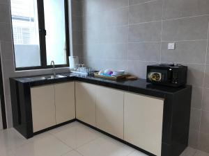 a bathroom with a sink and a radio on a counter at 75 Cozy Home - Homestay Kluang (Gated and Guarded, Northern European Interior) in Kluang