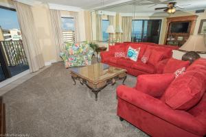 a living room with red couches and a coffee table at Inlet Reef 616 Destin Condo in Destin