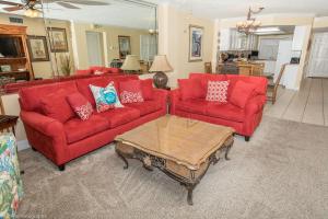 a living room with red couches and a coffee table at Inlet Reef 616 Destin Condo in Destin