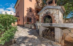 a building with a fireplace in front of it at Apartment Nino in Kanfanar