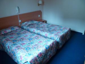 Letto o letti in una camera di Hôtel Gloria & Avenue