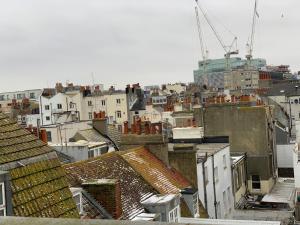 a view of a city with roofs and a building at Legends Hotel in Brighton & Hove