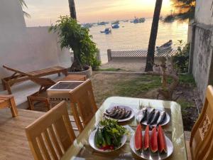 a table with plates of food on top of it at TS Beach House in Phú Quốc