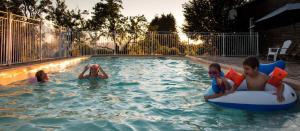 a group of children in a swimming pool at Gite E'table Charlannes in Hautefage