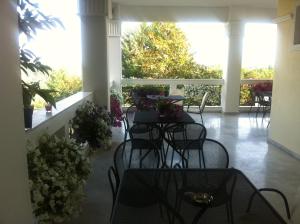 a group of tables and chairs on a patio at Hotel Αchillion Grevena in Grevena
