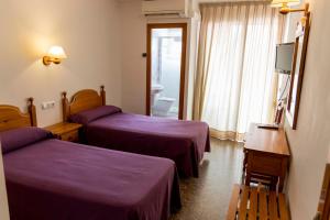 Postel nebo postele na pokoji v ubytování Hotel Herasu