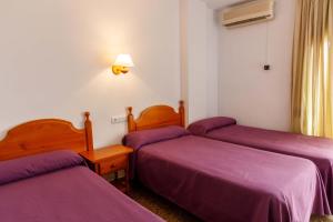 Postel nebo postele na pokoji v ubytování Hotel Herasu
