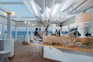 a restaurant on a cruise ship with the ocean in the background at Le Ruve Bianche in Vibonati