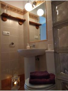 a bathroom with a sink and a toilet and a mirror at El Rincón de Bolonia in Bolonia